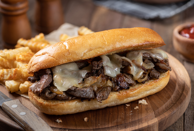 Philly cheesesteak sandwich and french fries