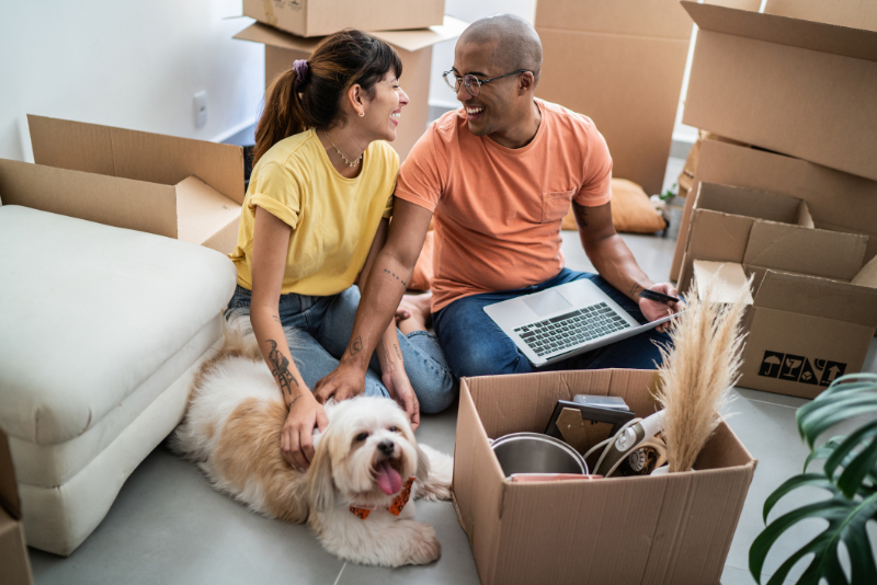 couple moving on their new house with their dog