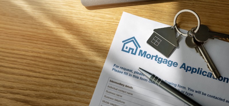 mortgage loan application form for buying homes in Phoenixville PA and new home keys on the bank office table