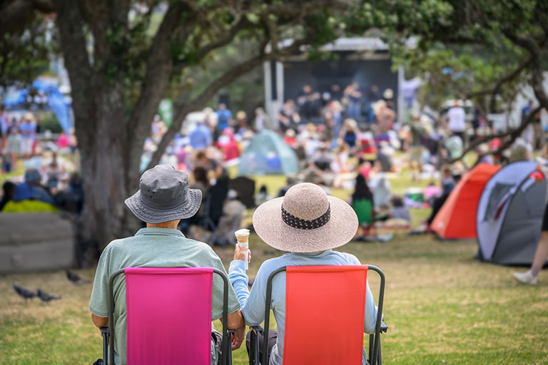 Couple sitting on camping chairs